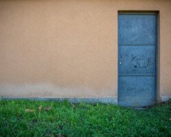 Grey door in beige wall