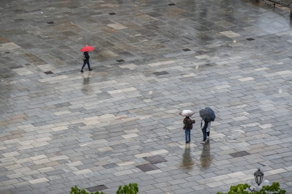 Space 8:  Mobile boundaries drifting across a vast, wet grid—each overhead canopy carving out a personal, watertight territory within the shared expanse.